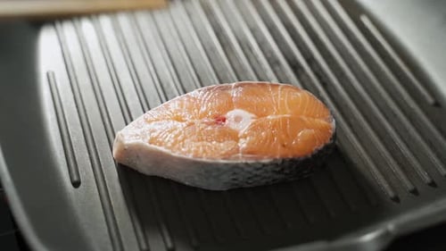 Fresh Salmon Steak Placed on Grill Pan