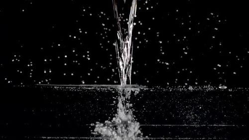 Water Pouring and Splashing on Black Background