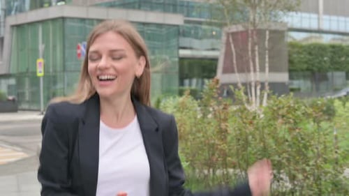 Young Businesswoman Dancing in Joy While Walking on the Street