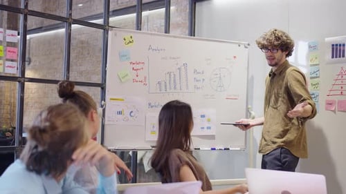 Team Collaboration During Data Analysis Presentation in Office