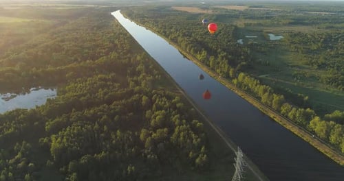Hot Air Balloons Float Over the Canal at Sunrise