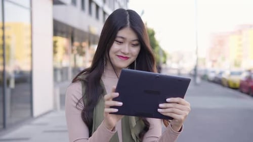 Young Asian Woman Works Tablet Smile Street Urban Area