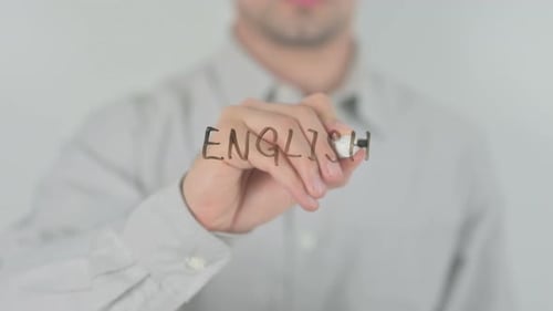 Man Writes the Word English with Black Marker