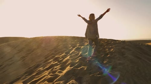 Blonde Model Walking Barefeet Reaching the Top of the Sand Dune