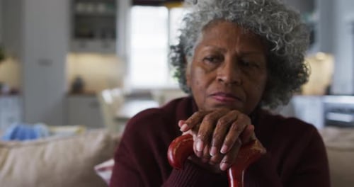 Senior Woman Resting Indoors with Cane