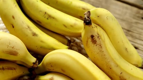 Vibrant Yellow Bananas on Woven Surface Close Up