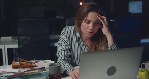 Tired Woman Working on Laptop Alone in Dark Office Late at Night, Stressed Girl Proping Head