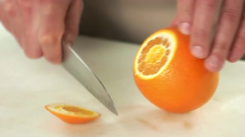 Cutting Fresh Orange with Sharp Knife