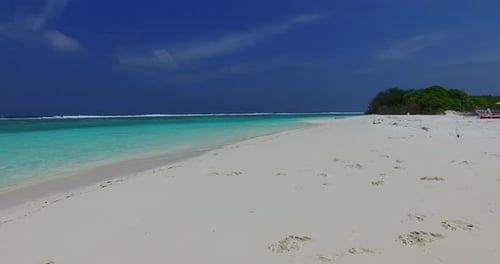 Wide above abstract shot of a paradise sunny white sand beach and blue water background in vibrant 4
