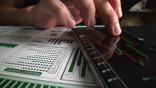 Accountant Analyzing Business Marketing Data on Paper Dashboard at Office Table