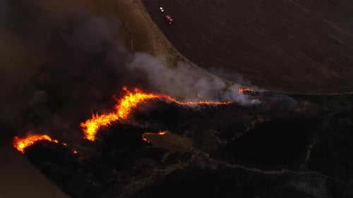 Aerial View of Wildfire Burning Across Rural Landscape