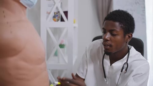 Doctor Marking Patient's Torso for Procedure in Office