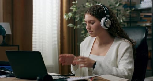 Woman Relaxing with Music at Desk