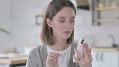 Woman Using Phone Reacting to Bad News