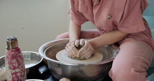 Woman Shaping Clay on Pottery Wheel in Studio