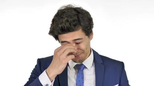 Man Rubbing Face in Discomfort on White Background