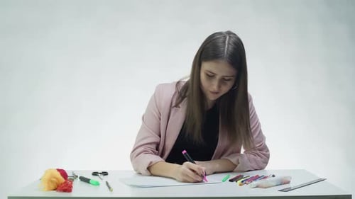 Woman Drawing With Markers at Desk