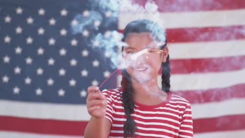 Girl Holding Sparkler With American Flag Background