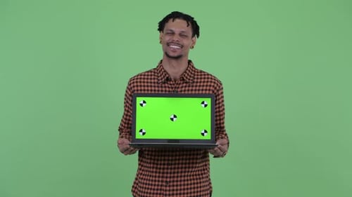Young Man Holds Laptop with Green Screen