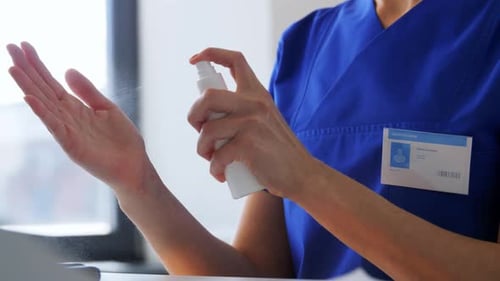 Doctor or Nurse Using Hand Sanitizer at Hospital