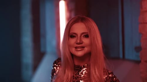 Woman Singer with Bright Makeup Sings a Song in the Studio for a Music Video