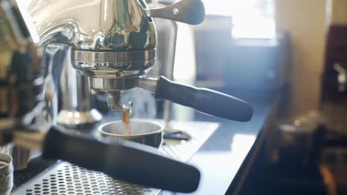 Coffee Pouring from Gleaming Espresso Machine