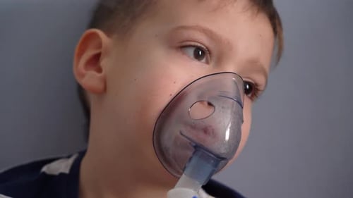 Child Using Nebulizer and Mask for Treatment