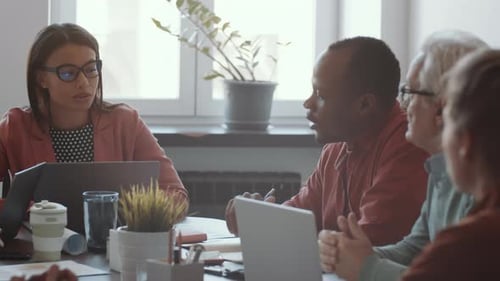 Diverse Team Collaborates in Modern Office Environment