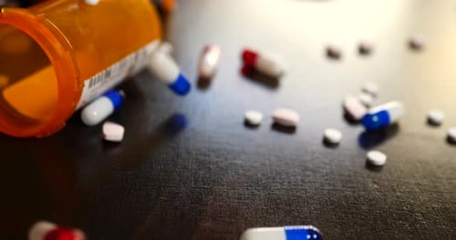 Scattered Pills and Capsules on a Dark Surface