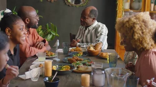 Friends and Family Gather Around Table for Meal