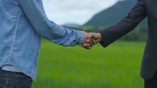 Handshake Between Two People in Rural Setting