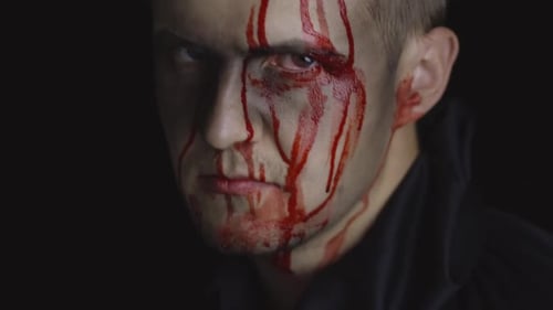 Intense Man with Blood Streaming Down Face