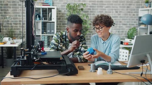 Smiling People Sharing Ideas About 3D Printer Model, Equipment Working in Office