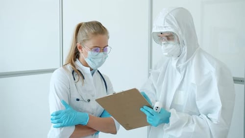 Slow Motion of Doctors in Uniform and Masks Discussing Work in Hospital