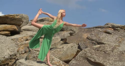 Woman Performs Yoga Pose in Rocky Landscape