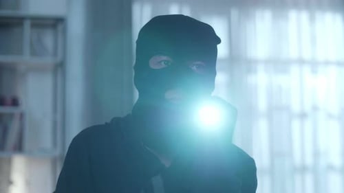 Close Up Of A Thief Man Holding Flashlight Walking In Someone's House