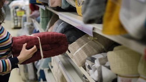 Closeup of Woman Buying Plaid in a Store for Home