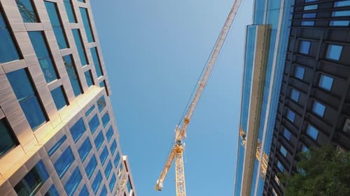 Large Construction Crane in the City Center Near Glass Office Buildings