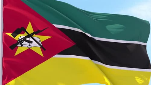 Waving Flag of Mozambique in Realistic Motion Against Blue Sky