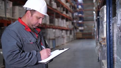 The Employee Rewrites the Goods in the Logistics Warehouse