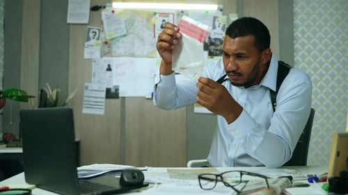 Detective Inspecting Evidence in Police Investigation Office