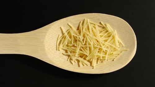 Raw Noodles Filling Wooden Spoon