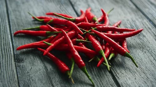 Fresh Red Chili Peppers on Wood Table