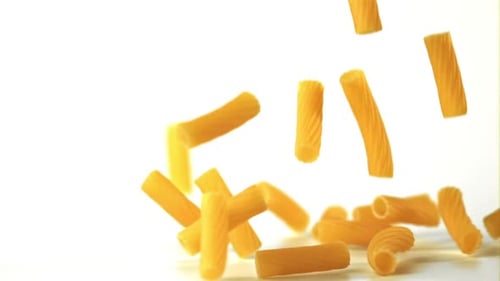 Rigatoni Pasta Falling in Slow Motion on White