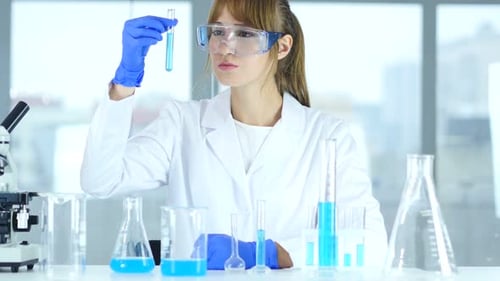 Woman Scientist Analyzing Test Tube in Lab