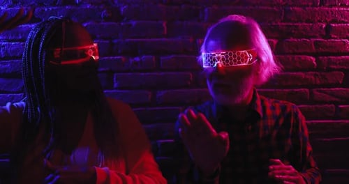 Senior and adult with futuristic glasses pose