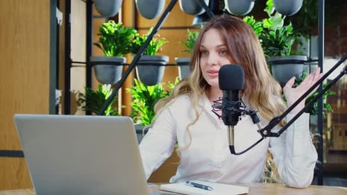Young Woman Recording a Podcast at Desk