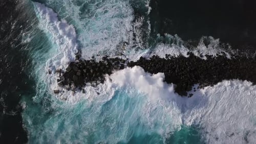 Overhead View of Waves Splash on Rocks