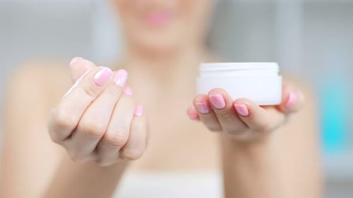 Woman Uses Luxurious Face Cream for Skincare
