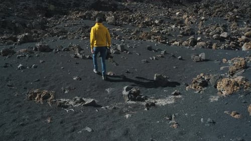 Man Traveler Walks Through the Lava Field Around Chinyero Volcano in the Teide National Park on the